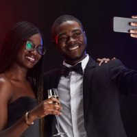 Young African-American Couple Taking Selfie at Party